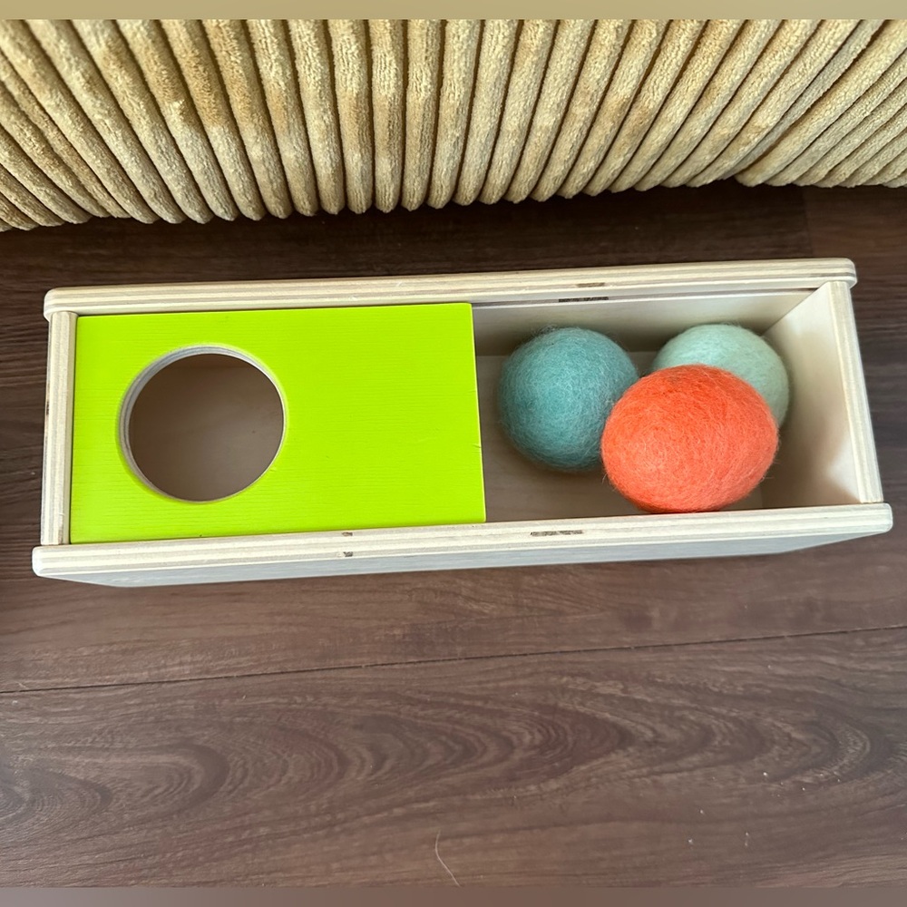 Lovevery ball hiding/sliding toy
